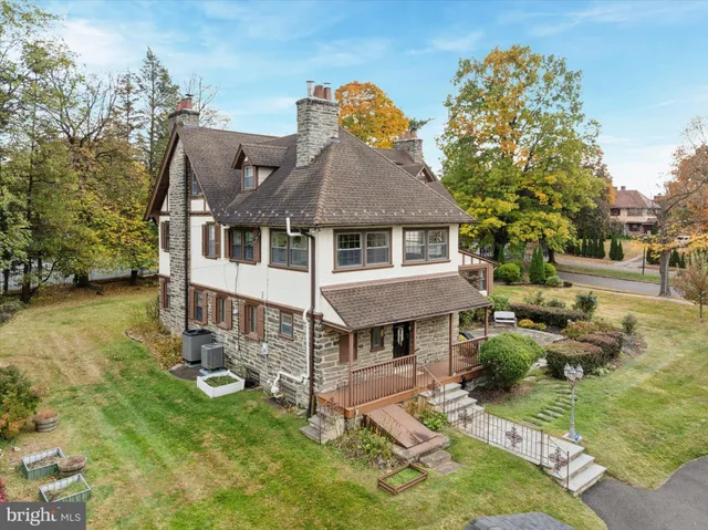 a aerial view of a house with swimming pool and sitting area