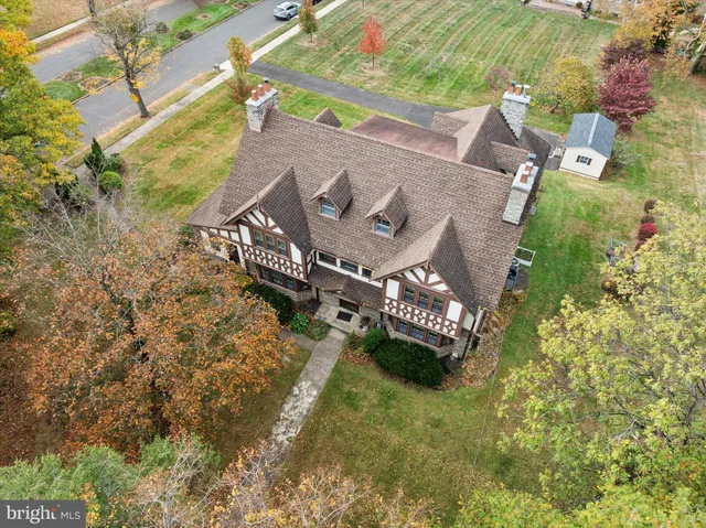 an aerial view of a house with a garden and swimming pool