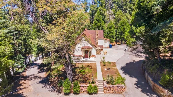 an aerial view of a house with a yard
