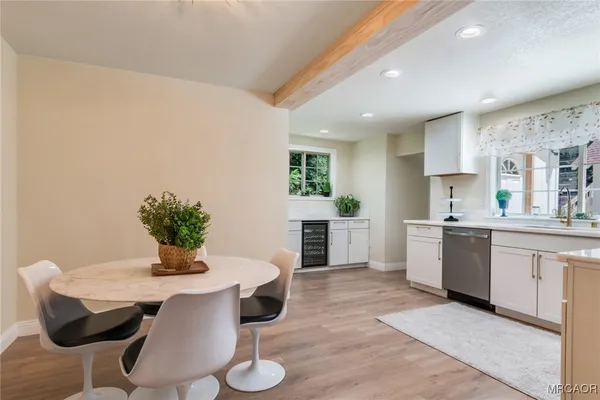 a kitchen with a table and chairs in it