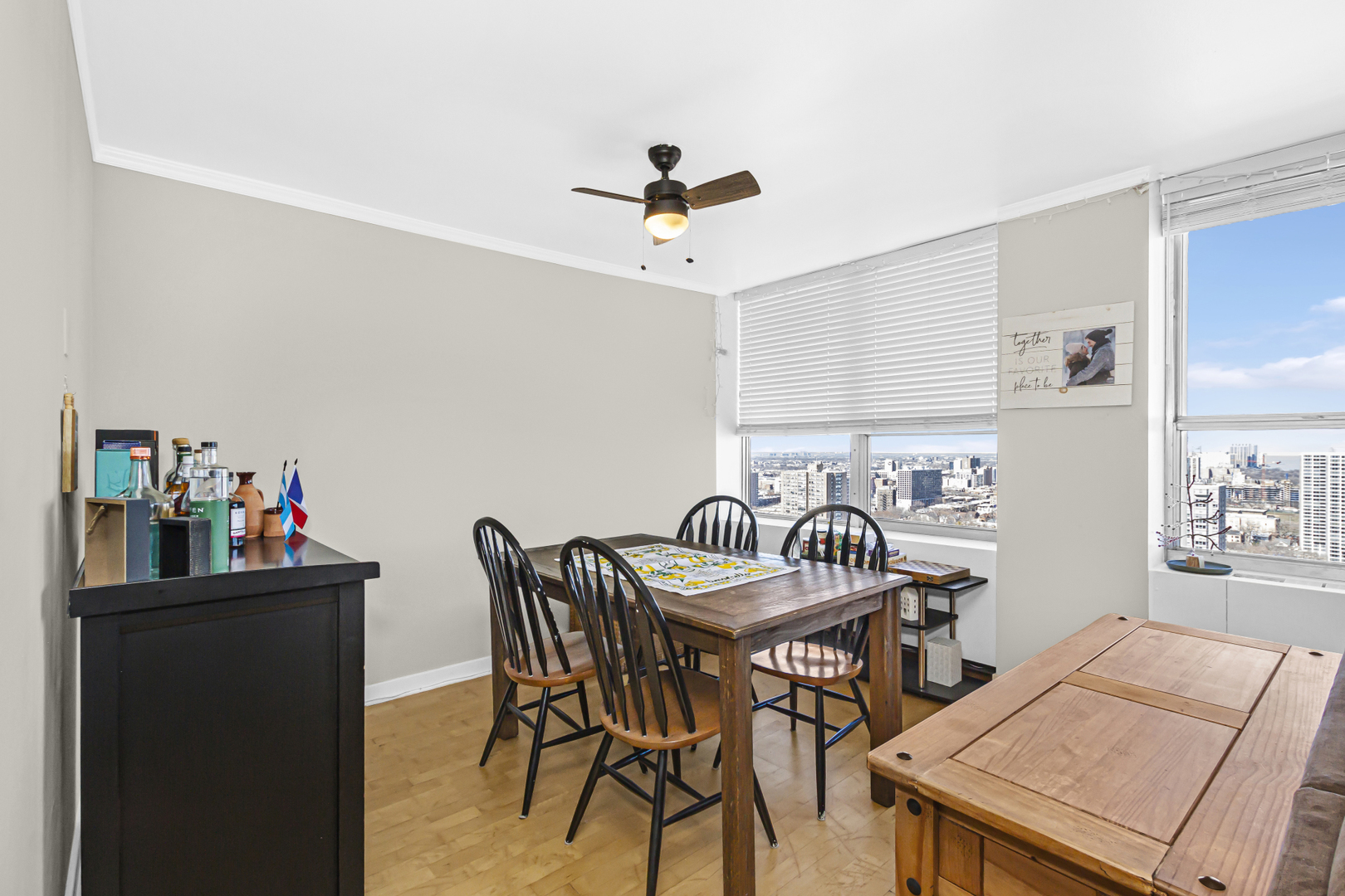 655 West Irving Park Road, Unit 2912 Chicago, IL 60613 - Photo 11 of 23 a view of a a dining room with furniture window and wooden floor