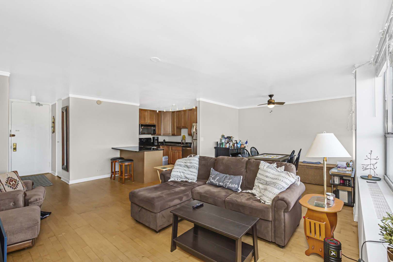 655 West Irving Park Road, Unit 2912 Chicago, IL 60613 - Photo 5 of 23 a living room with furniture and a view of kitchen