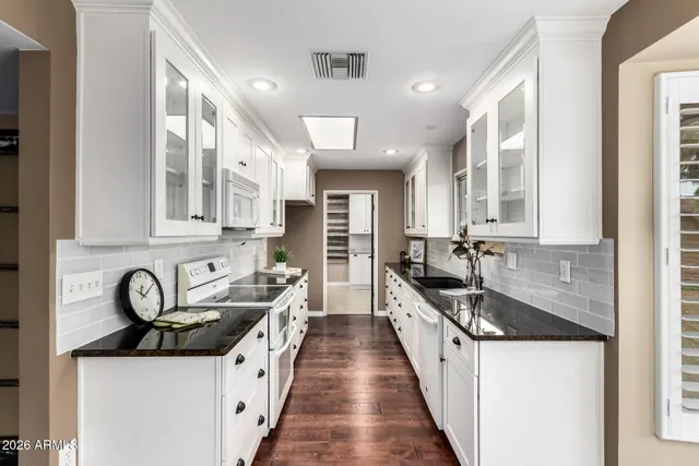 a kitchen with stainless steel appliances a sink stove and cabinets