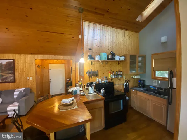 a kitchen with counter space sink stove and chairs