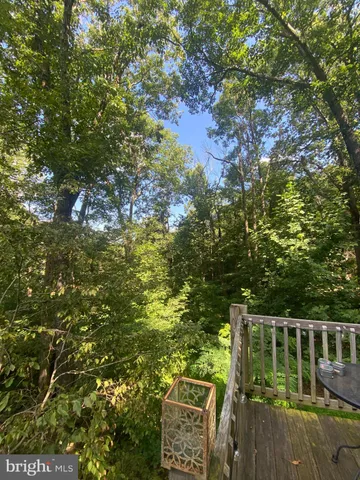 a balcony with wooden floor and yard