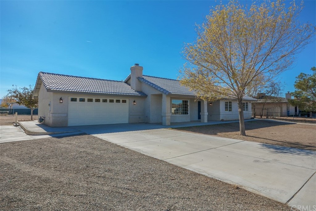 22197 Gayhead Road Apple Valley, CA 92307 - Photo 1 of 1 a front view of a house with a yard and garage