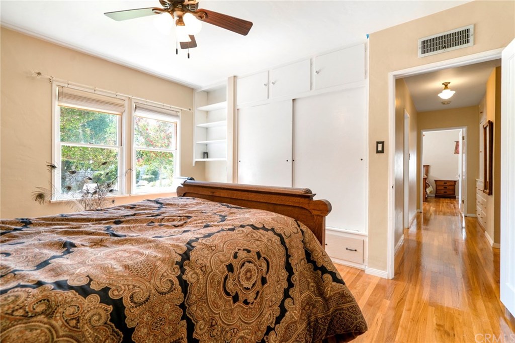 4682 Sunnyside Drive Riverside, CA 92506 - Photo 23 of 35 Alternate view of Bedroom #2, complete with hardwood floors, ceiling fan, built-in shelving, and lots of closet space.