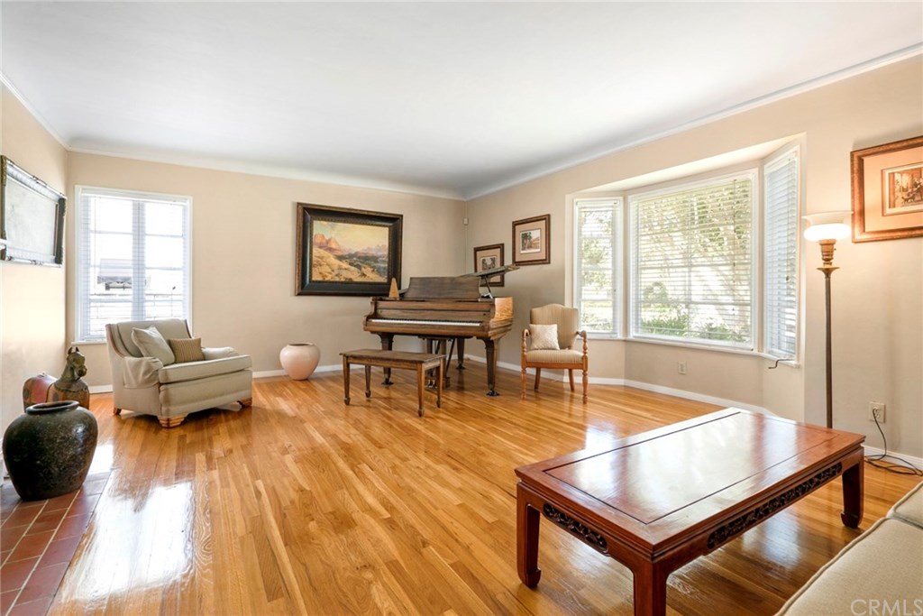 Large living room with hardwood floors, fireplace, and lots of natural light.