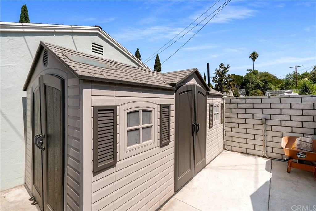 4682 Sunnyside Drive Riverside, CA 92506 - Photo 34 of 35 Behind the garage, you'll find two sheds with electricity on slab. Very neat and orderly, perfect for extra storage and/or play houses.