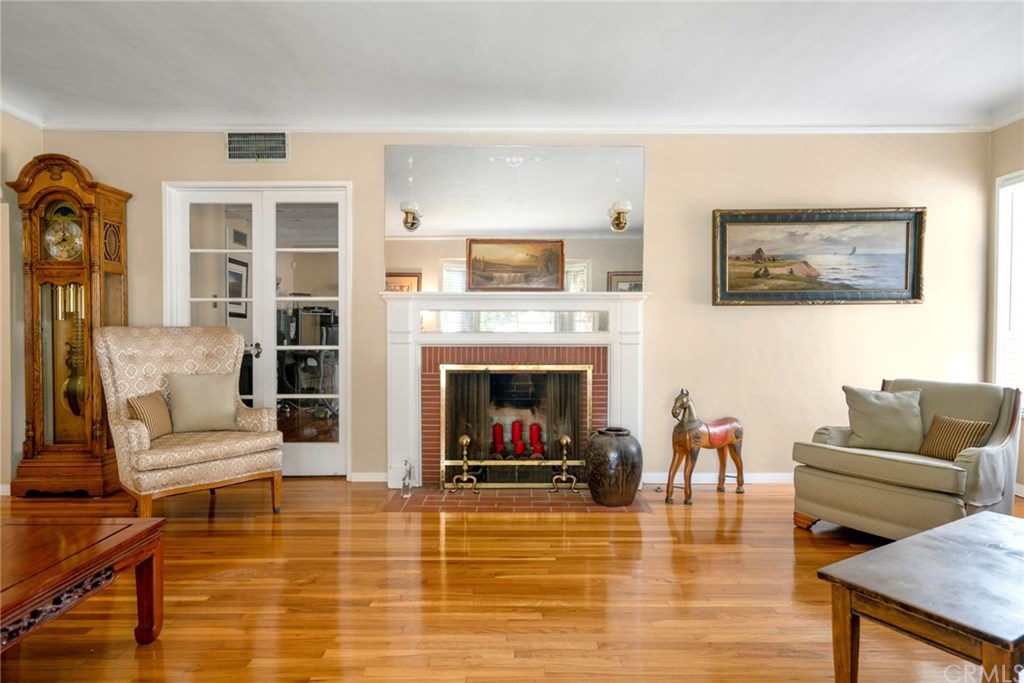 Living room fireplace with French doors leading to the 2-level den.