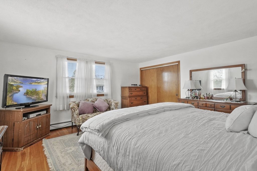 95 Gregory Street Waltham, MA 02451 - Photo 18 of 36 a bedroom with a bed and a flat screen tv