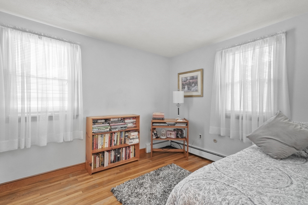 95 Gregory Street Waltham, MA 02451 - Photo 23 of 36 a bedroom with a bed and wooden floor