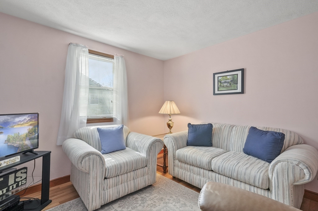 95 Gregory Street Waltham, MA 02451 - Photo 26 of 36 a living room with furniture and a flat screen tv