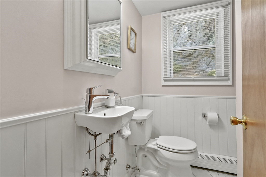 95 Gregory Street Waltham, MA 02451 - Photo 27 of 36 a bathroom with a toilet a sink and mirror
