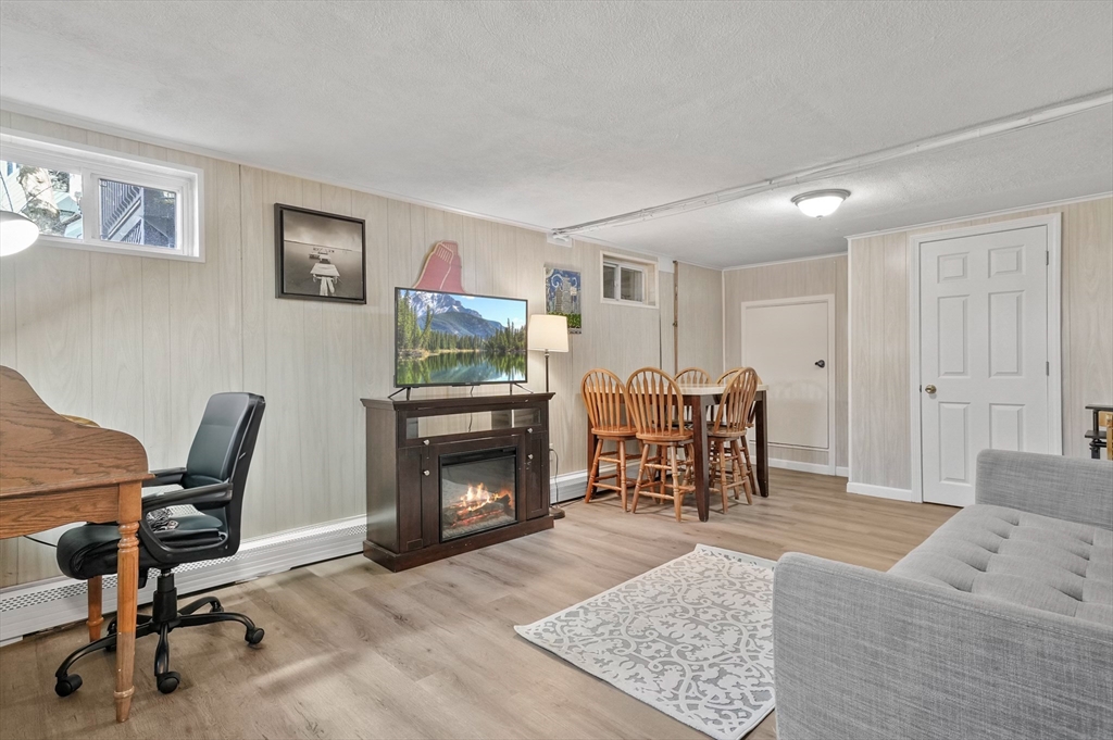95 Gregory Street Waltham, MA 02451 - Photo 30 of 36 a living room with furniture and a fireplace
