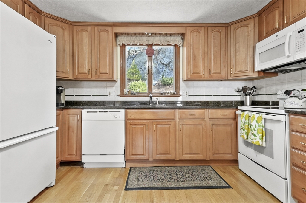 95 Gregory Street Waltham, MA 02451 - Photo 3 of 36 a kitchen with granite countertop cabinets and window