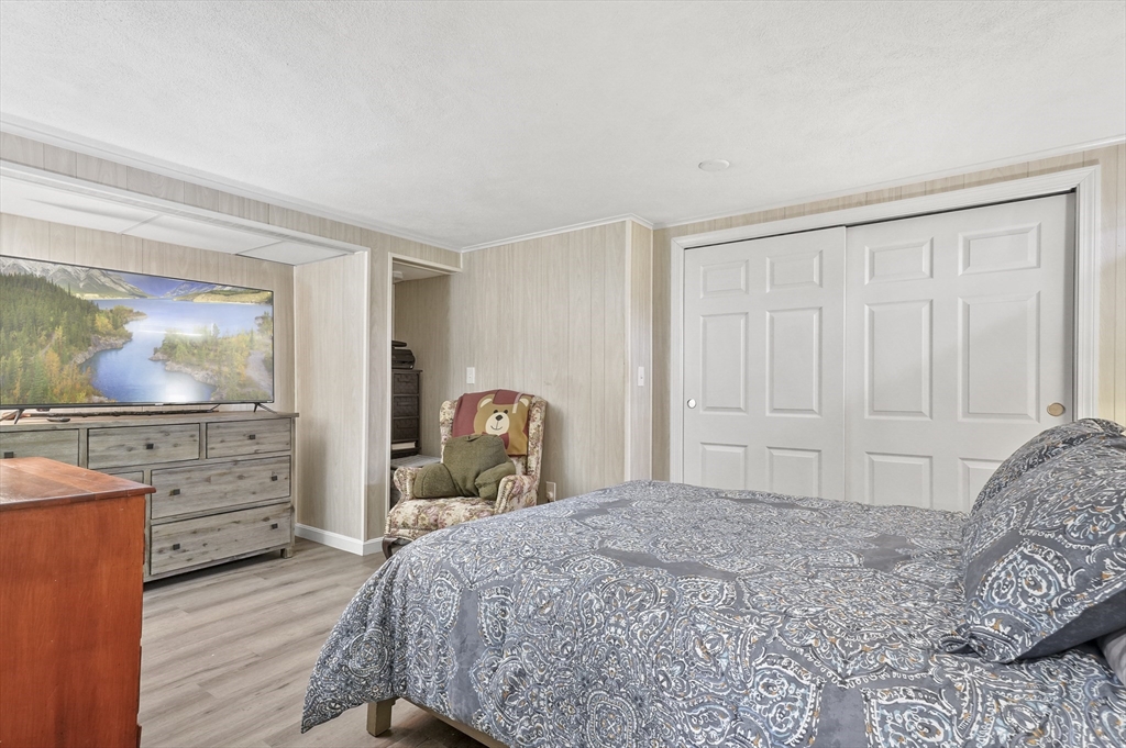 95 Gregory Street Waltham, MA 02451 - Photo 31 of 36 a bedroom with a bed and a cabinets