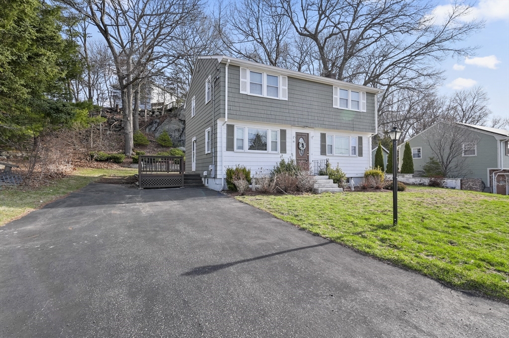 95 Gregory Street Waltham, MA 02451 - Photo 33 of 36 a front view of a house with a yard and trees
