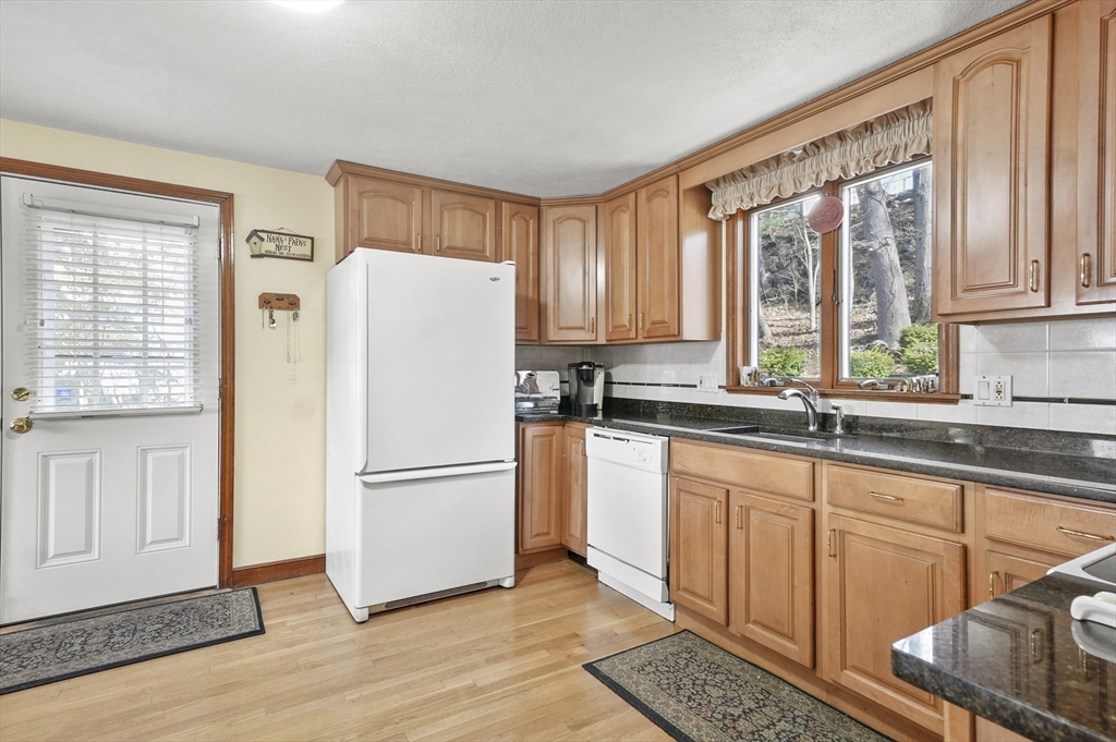 95 Gregory Street Waltham, MA 02451 - Photo 4 of 36 a kitchen with stainless steel appliances a refrigerator sink and cabinets