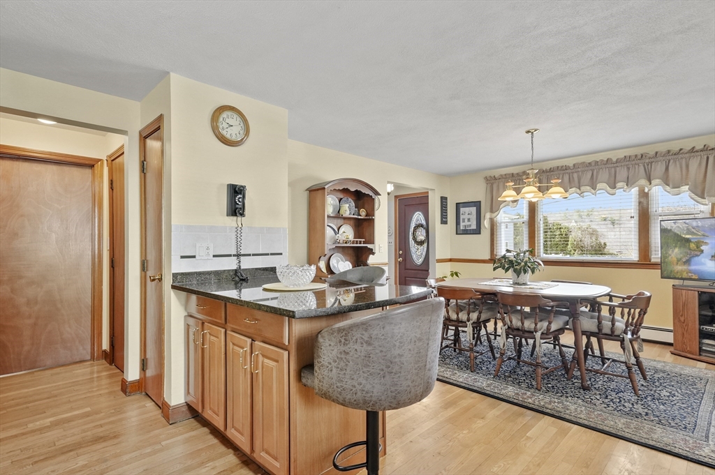 95 Gregory Street Waltham, MA 02451 - Photo 6 of 36 a dining hall with granite countertop a dining table and chairs