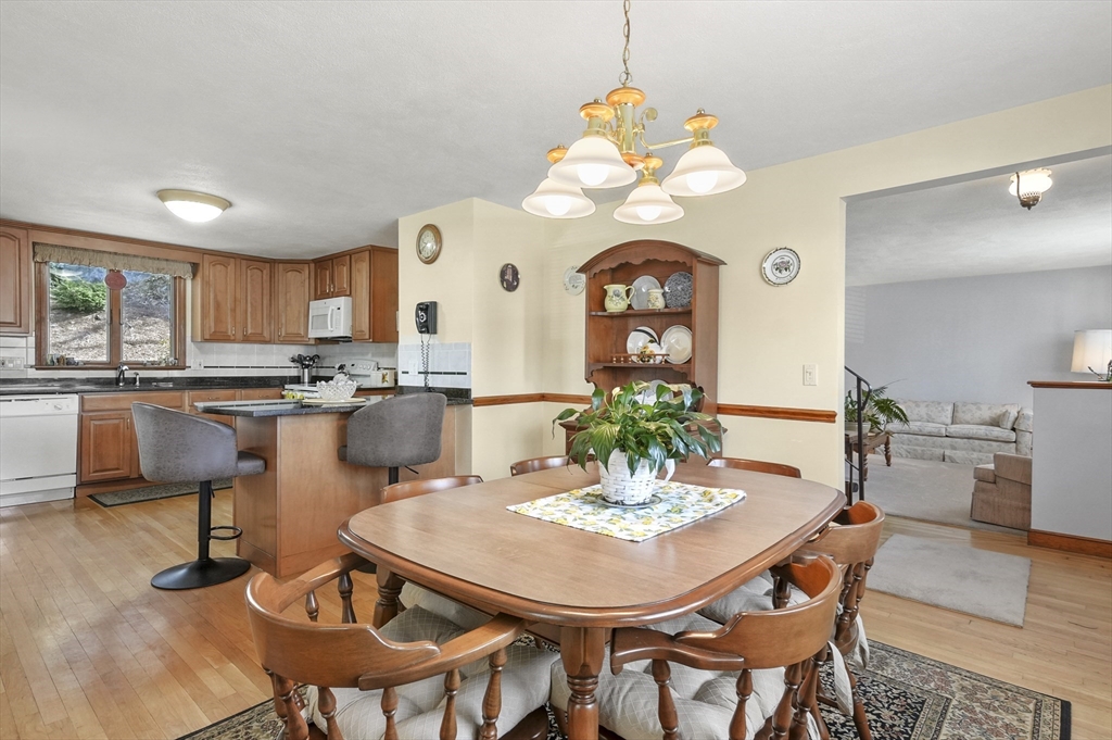 95 Gregory Street Waltham, MA 02451 - Photo 10 of 36 a dining room filled chandelier and wooden furniture