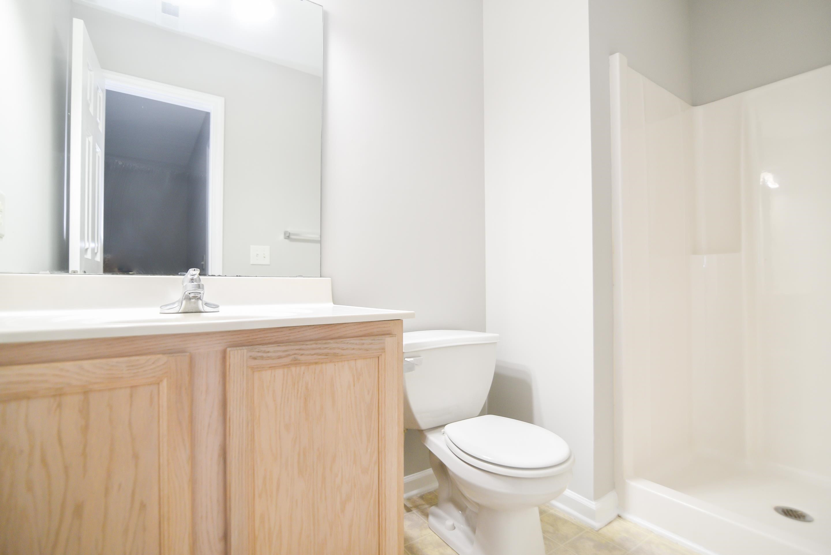 69 Red Lane Raleigh, NC 27606 - Photo 15 of 18 Third floor bathroom offers a spacious vanity and walk-in shower. Bathroom