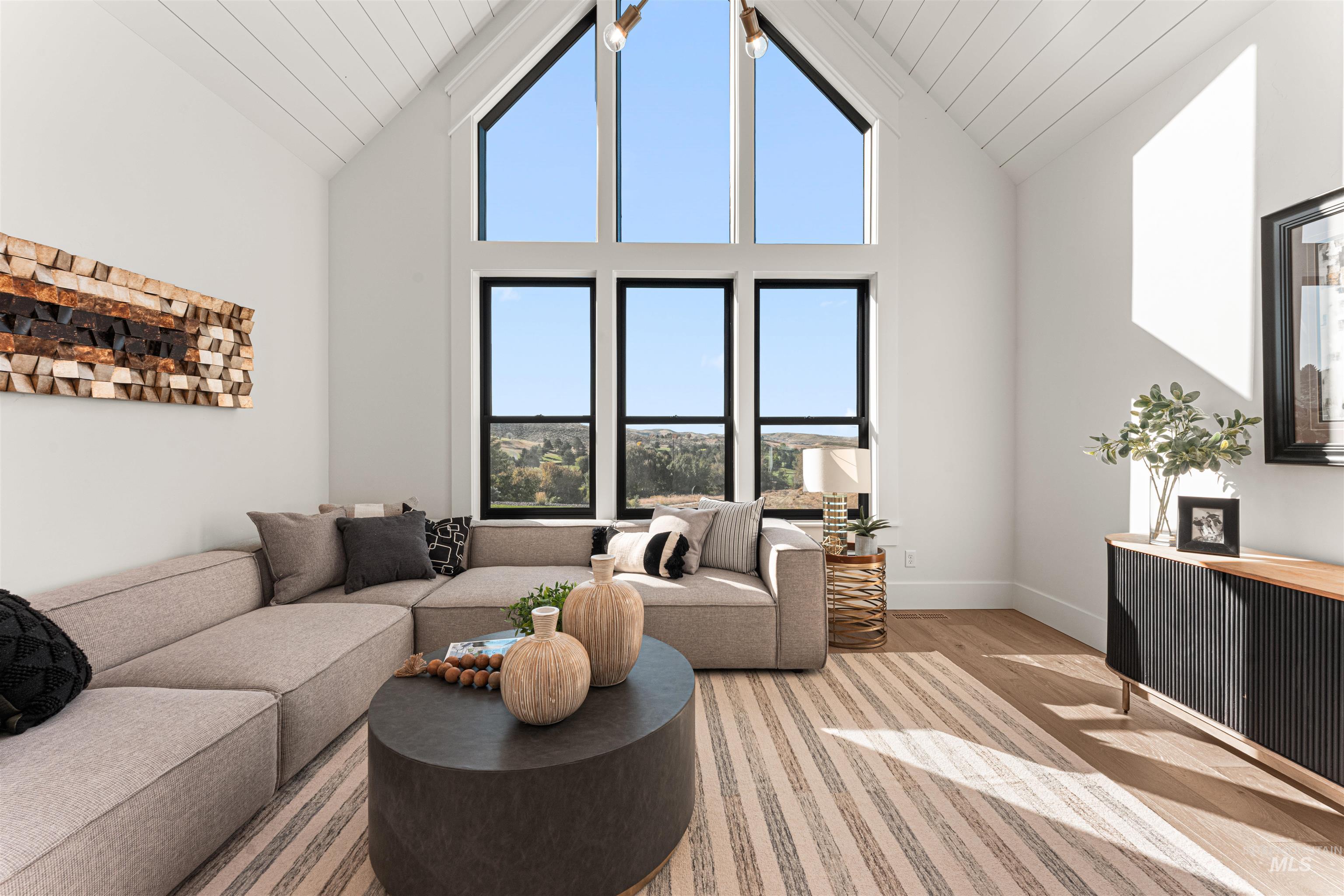 6400 North High Vly Way Eagle, ID 83714 - Photo 20 of 49 Living area featuring high vaulted ceiling and wood finished floors