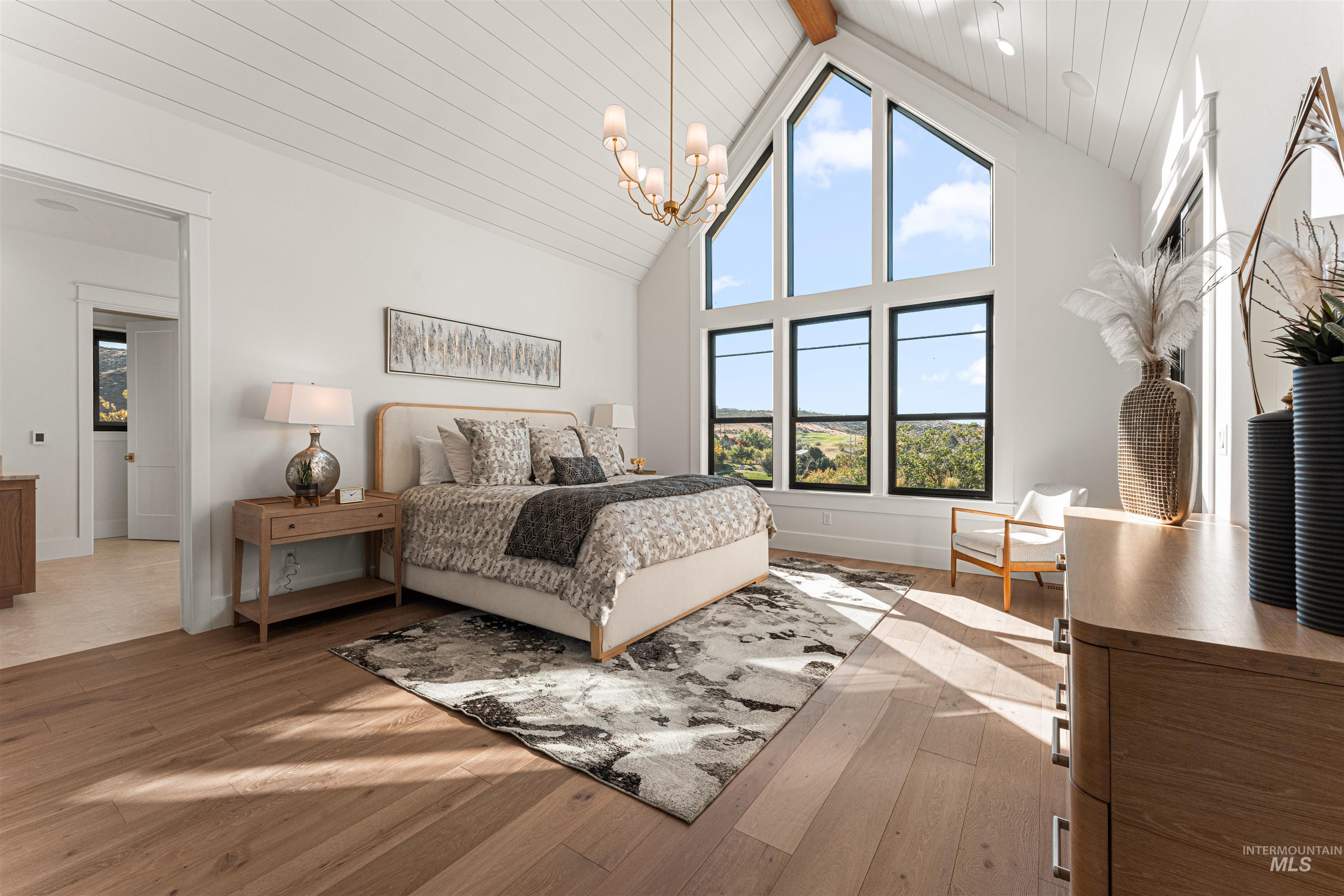 6400 North High Vly Way Eagle, ID 83714 - Photo 21 of 49 Bedroom featuring light wood finished floors, high vaulted ceiling, a chandelier, and a wooden ceiling with exposed beams