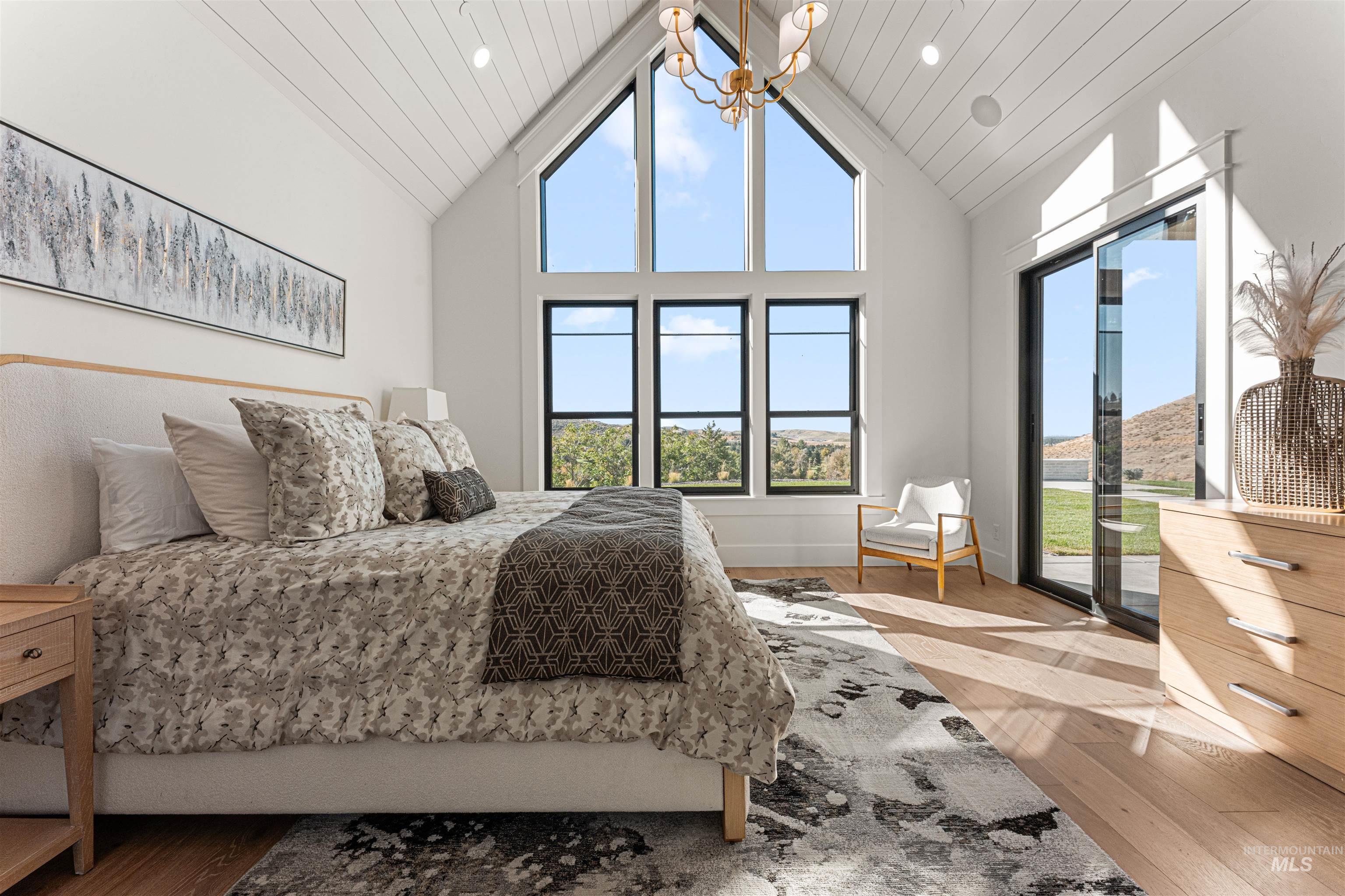 6400 North High Vly Way Eagle, ID 83714 - Photo 22 of 49 Bedroom with wood finished floors, high vaulted ceiling, multiple windows, access to exterior, and wooden ceiling