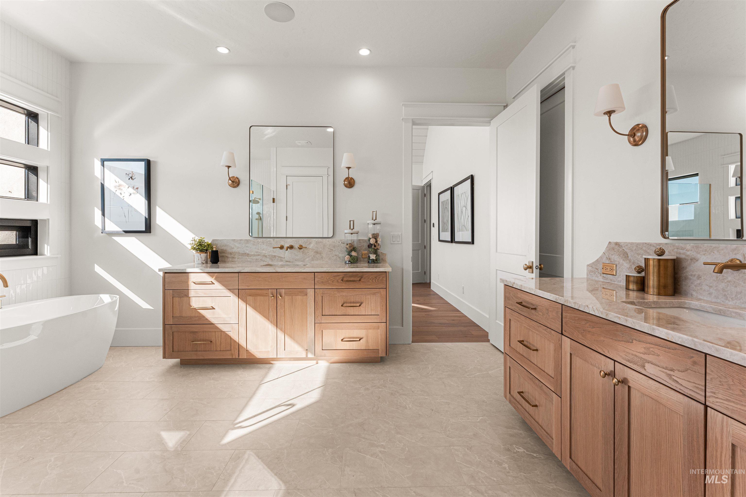 6400 North High Vly Way Eagle, ID 83714 - Photo 24 of 49 Full bathroom featuring decorative backsplash, two vanities, a soaking tub, recessed lighting, and light tile patterned flooring