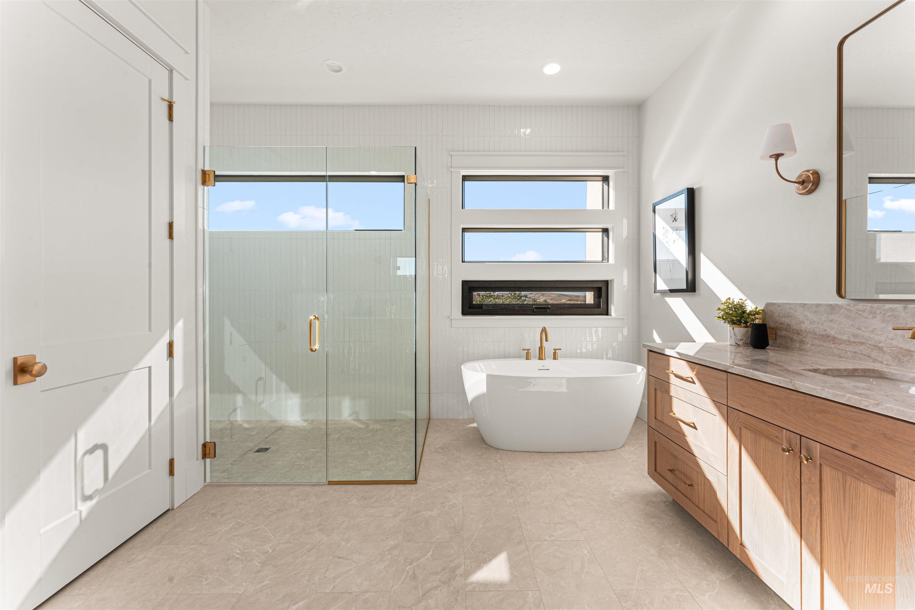 6400 North High Vly Way Eagle, ID 83714 - Photo 25 of 49 Bathroom featuring vanity, a soaking tub, a stall shower, healthy amount of natural light, and recessed lighting