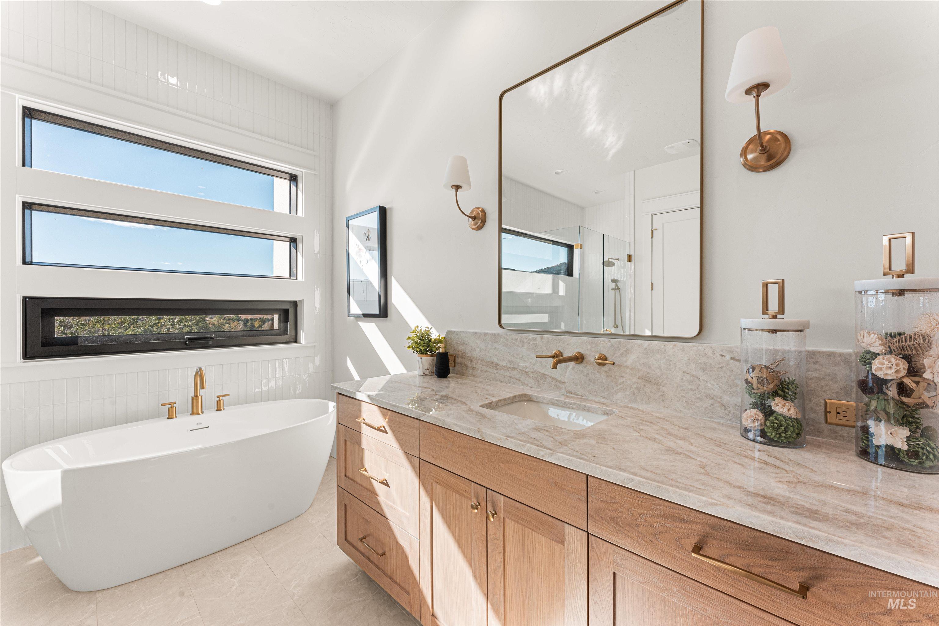 6400 North High Vly Way Eagle, ID 83714 - Photo 26 of 49 Bathroom featuring vanity, a stall shower, a freestanding bath, and light tile patterned floors