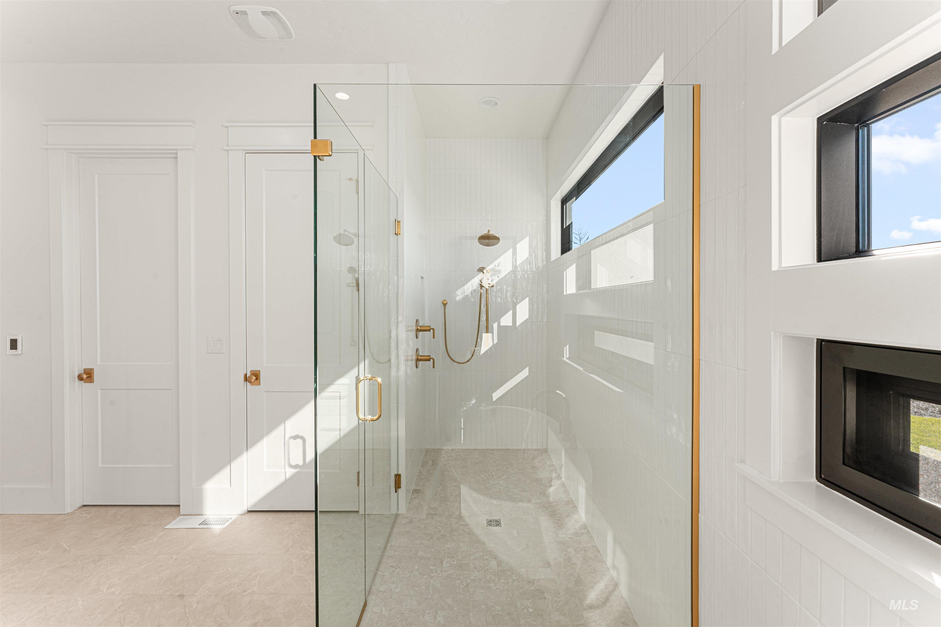 6400 North High Vly Way Eagle, ID 83714 - Photo 27 of 49 Bathroom featuring a shower stall and light tile patterned floors
