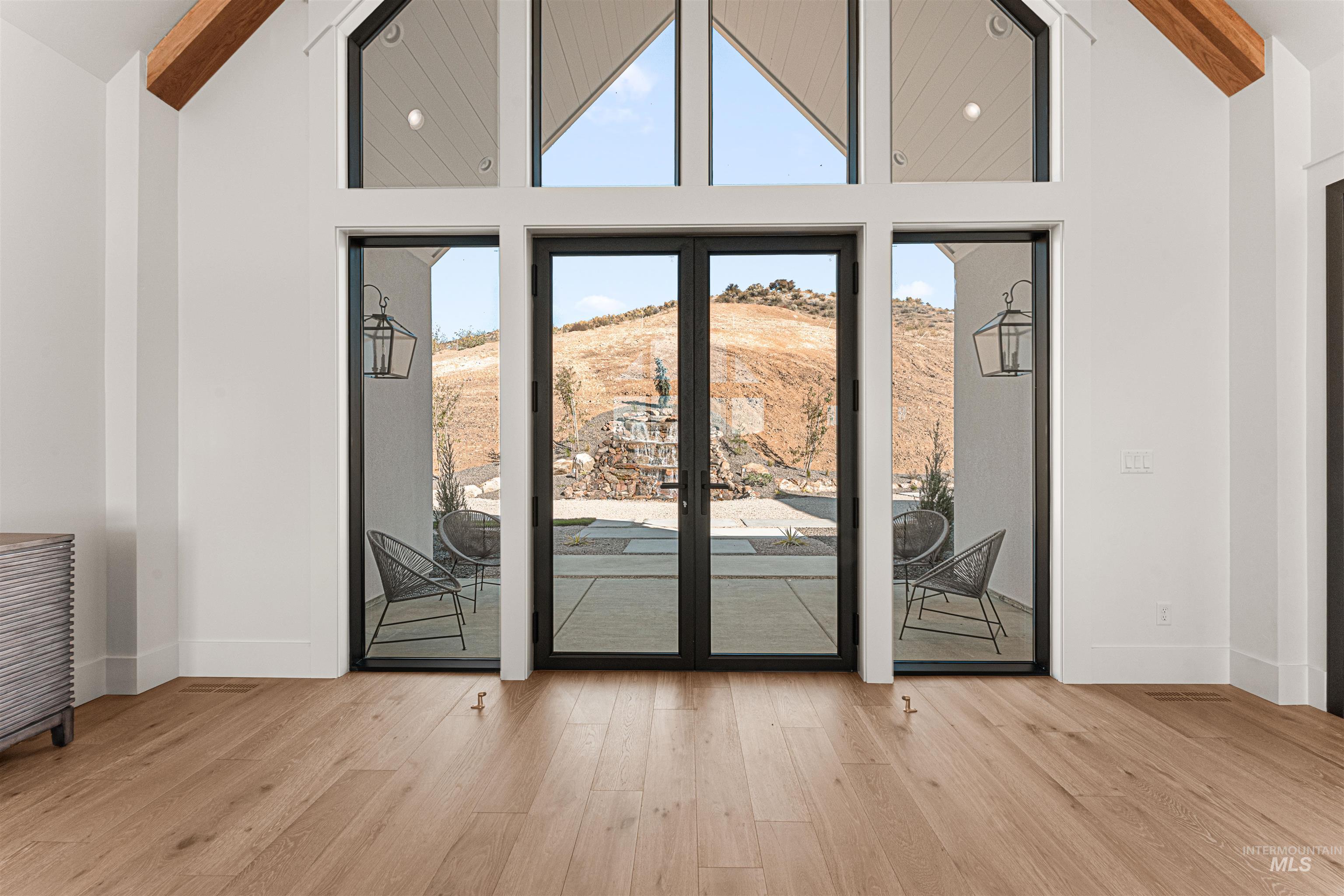 6400 North High Vly Way Eagle, ID 83714 - Photo 4 of 49 Entryway with high vaulted ceiling, wood finished floors, and beamed ceiling