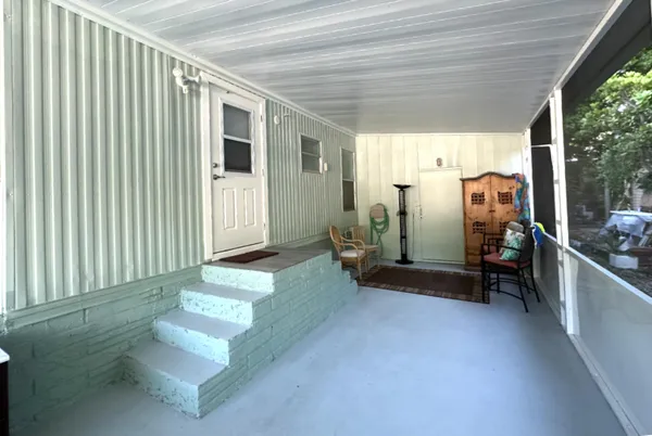 a view of a hallway with seating space