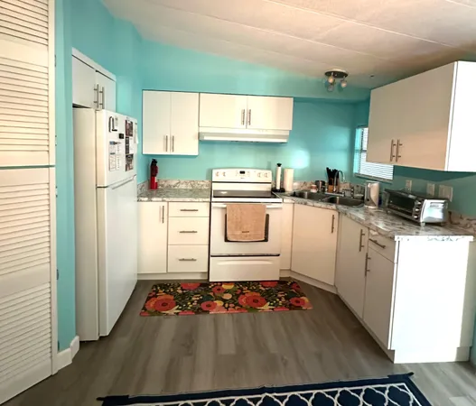 a kitchen with a sink stove and refrigerator