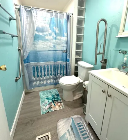a bathroom with a sink toilet and shower
