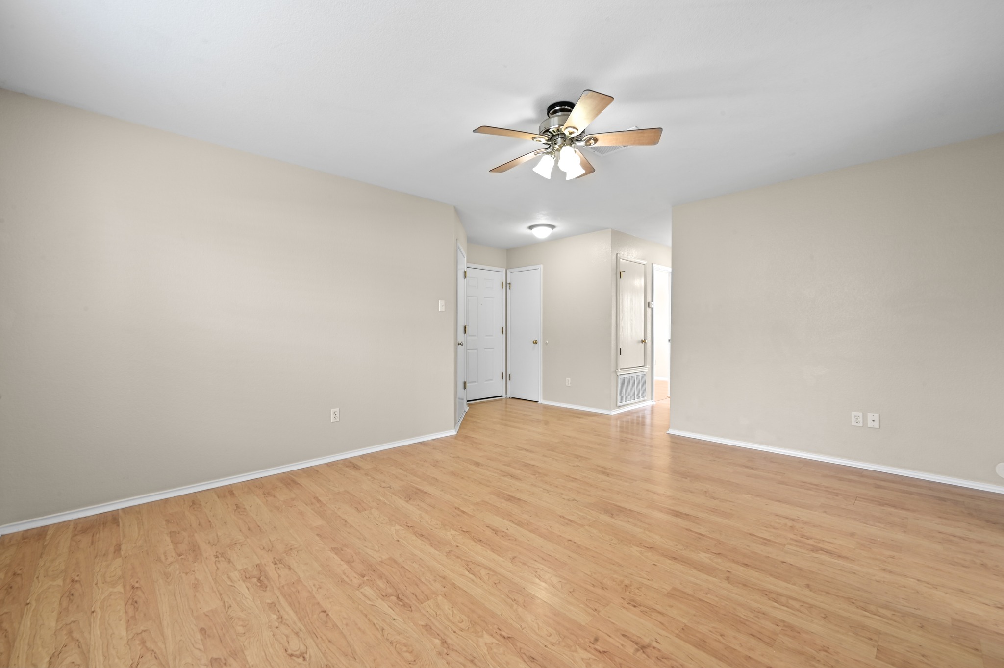 112 Mason Reed Cove Kyle, TX 78640 - Photo 7 of 26 an empty room with wooden floor fan and windows