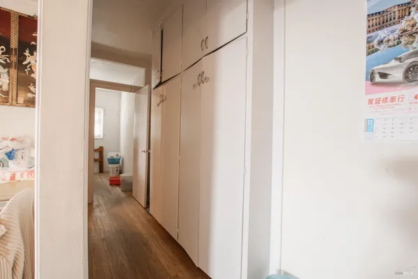 a view of a room with wooden floor