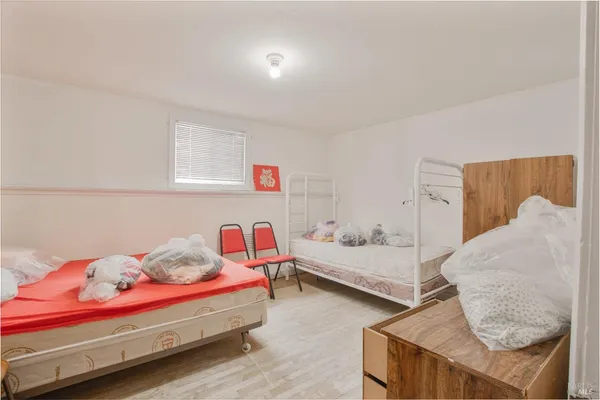 a view of a room with wooden floor a sink and a window
