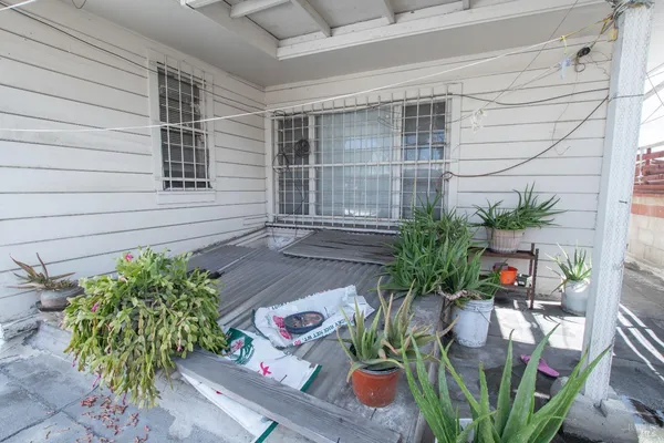 a utility room with lots of clutter and washer