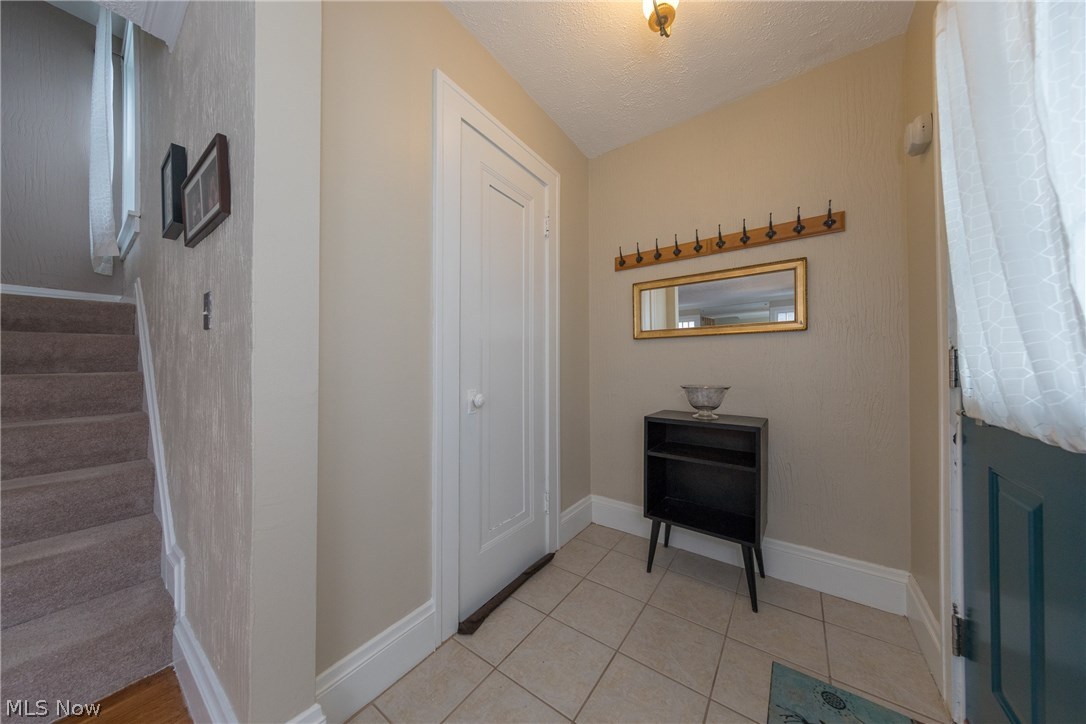 3996 Rosemond Road Cleveland Heights, OH 44121 - Photo 12 of 29 The front entryway, showing coat closet door and carpeted staircase leading up to the sleeping quarters