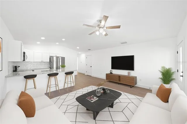 a living room with furniture and a flat screen tv