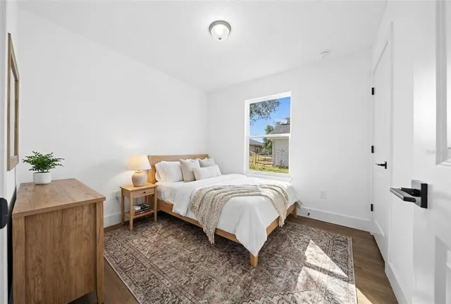 a bedroom with a bed and window