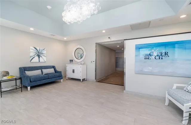 a living room with furniture and a baby crib