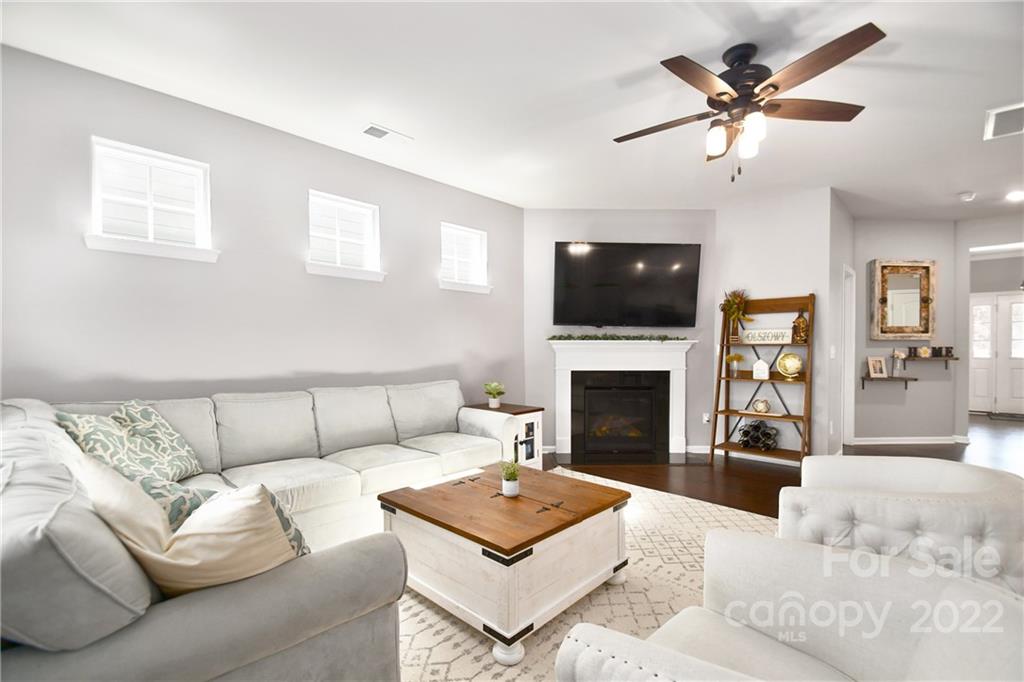 17239 Shearer Road Davidson, NC 28036 - Photo 12 of 32 a living room with furniture a flat screen tv and a fireplace