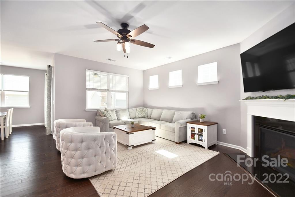 17239 Shearer Road Davidson, NC 28036 - Photo 13 of 32 a living room with furniture a flat screen tv and a fireplace