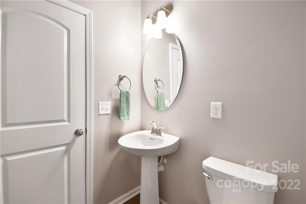 17239 Shearer Road Davidson, NC 28036 - Photo 15 of 32 a bathroom with a toilet a sink and a mirror