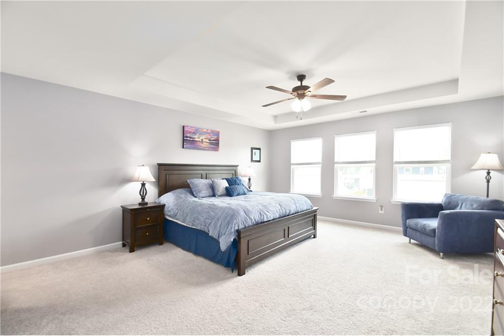 17239 Shearer Road Davidson, NC 28036 - Photo 17 of 32 a spacious bedroom with a bed painting on wall and a large window