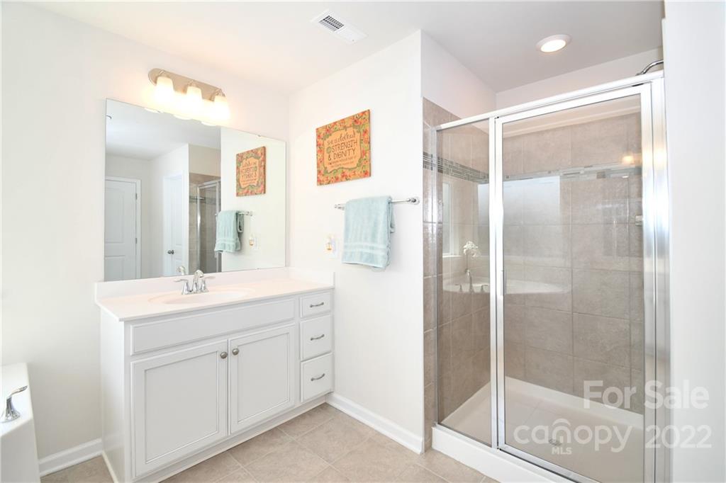 17239 Shearer Road Davidson, NC 28036 - Photo 20 of 32 a bathroom with a shower sink and mirror